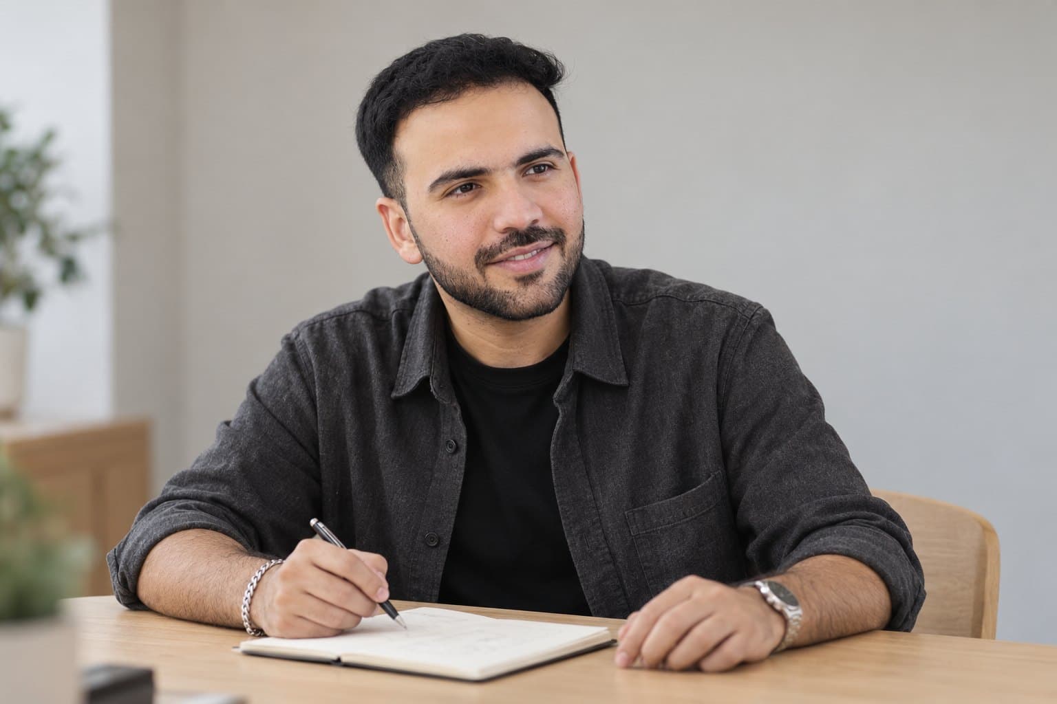 Shivam Mehta at a table, working through ideas in a notebook