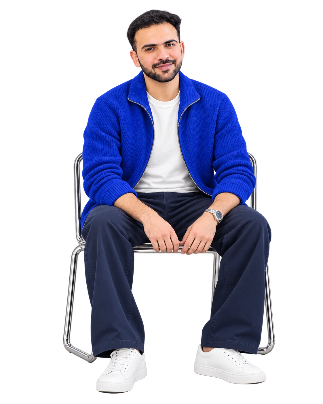 Shivam seated upright in a cobalt blue cardigan